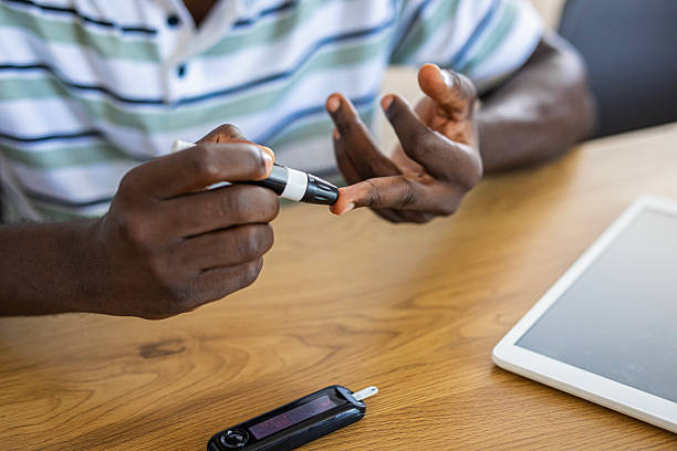 istock Young man with diabetes, checking his blood sugar level at home 2233162172