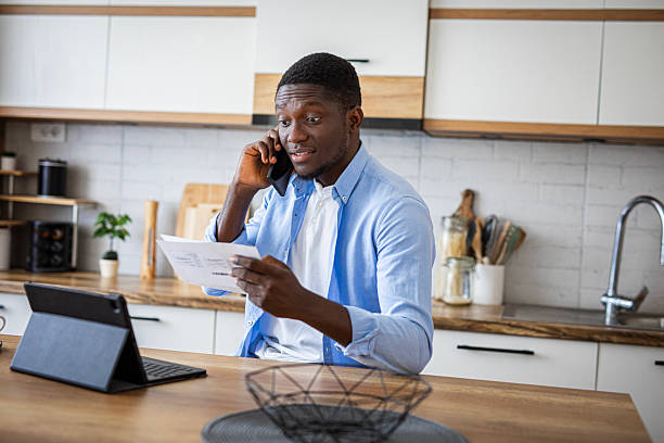istock Man working on his financial bills at home in kitchen 2233162771