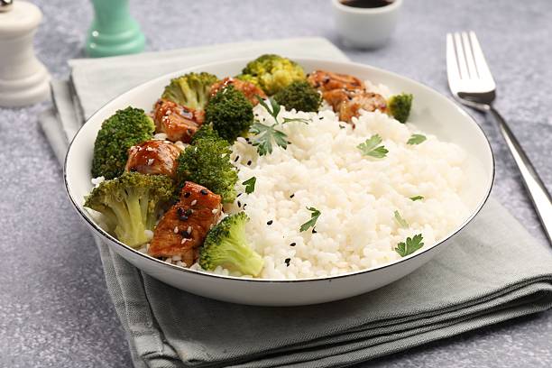 istock Tasty rice with broccoli and chicken served on grey table, closeup 2233163214