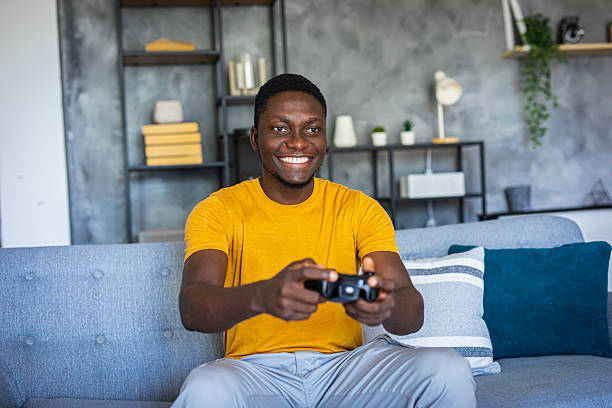 istock A man in a relaxing living room environment is focused playing a video game with a joystick 2233163232
