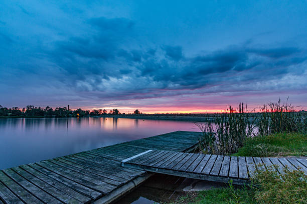 istock Dramatic sunrise illuminating a timber jetty at Walka Water Works 2233163407