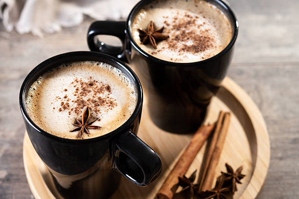 istock Chai Latte in Black Mug with Spices( star anise and cinnamon) on wooden table 2233165118