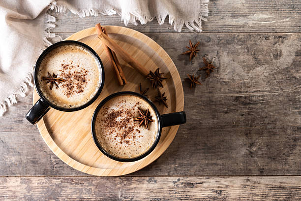 istock Chai Latte in Black Mug with Spices( star anise and cinnamon) on wooden table 2233165146