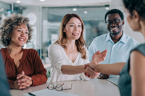 istock Businesspeople shaking hands across the table. 2233165239