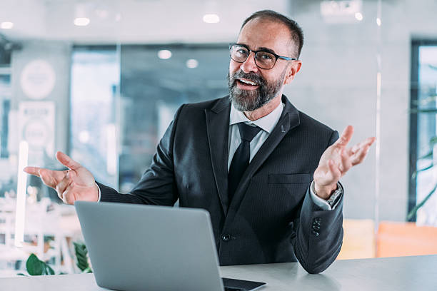istock Successful businessman in modern office working on laptop. 2233165255
