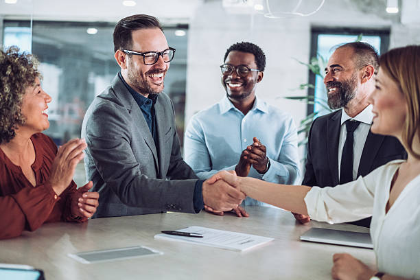 istock Businesspeople shaking hands across the table. 2233165268