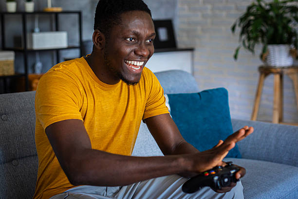 istock A man in a relaxing living room environment is focused playing a video game with a joystick 2233165842