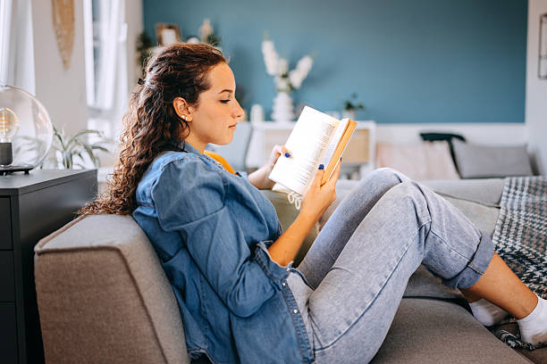istock Beautiful young woman relaxing at home using smartphone 2233165997