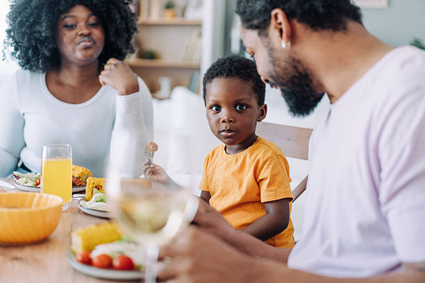istock Young family enjoying lunch together. 2233169229