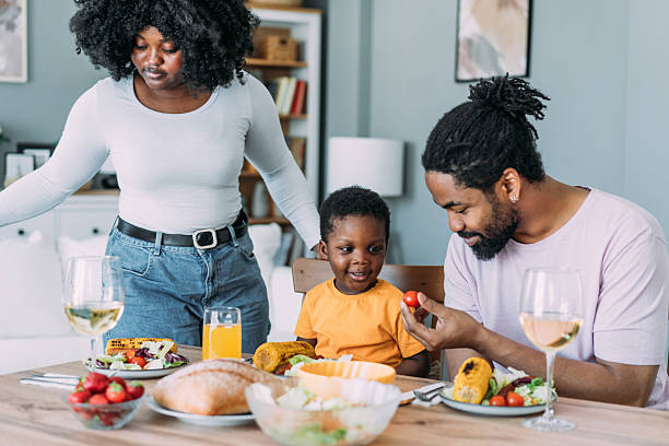 istock Young family enjoying lunch together. 2233169262