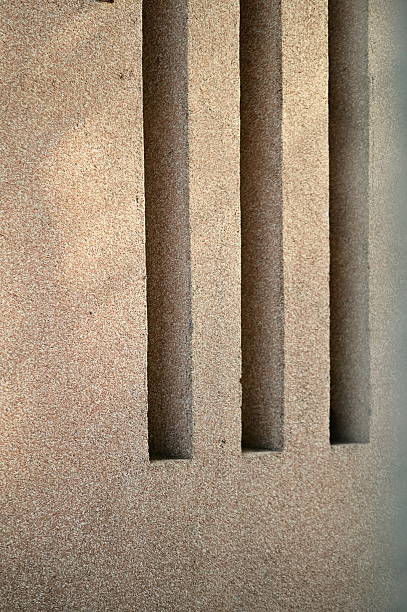 istock Textured Beige Surface with Three Vertical Dark Grooves Under Natural Directional Lighting 2233169901