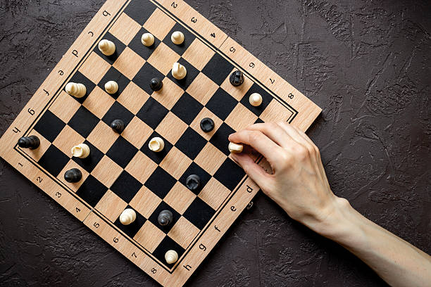 istock Hand is moving chess piece on chessboard. Game concept 2233171317