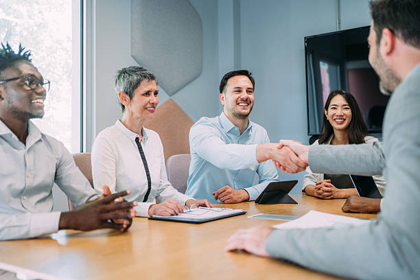 istock Businessmen shaking hands across the table. 2233172840
