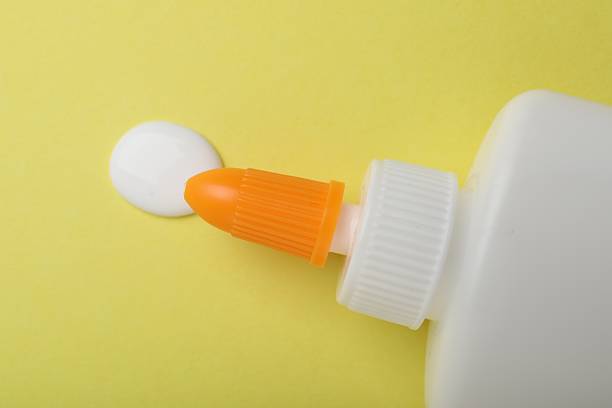 istock Bottle of glue on yellow background, top view 2233173195