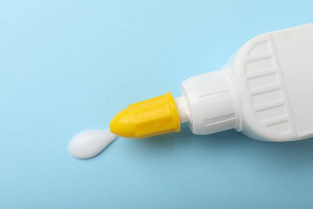 istock Bottle of glue on light blue background, top view 2233173211