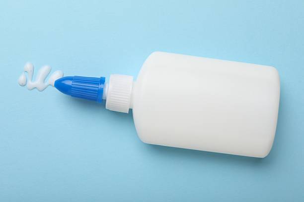 istock Bottle of glue on light blue background, top view 2233173241