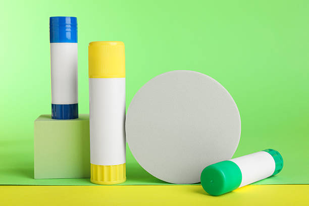istock Glue sticks and podiums on light green background 2233173335
