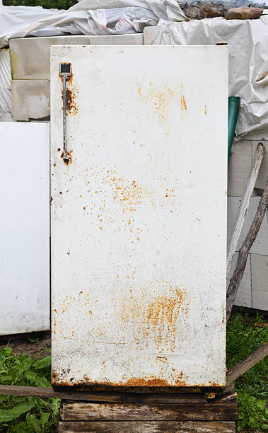 istock Old rusted refrigerator standing on a wooden pallet in a rural setting 2233173520