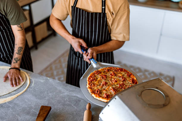 istock Fresh baked, thin crust, home made pizza directly from oven. 2233176575