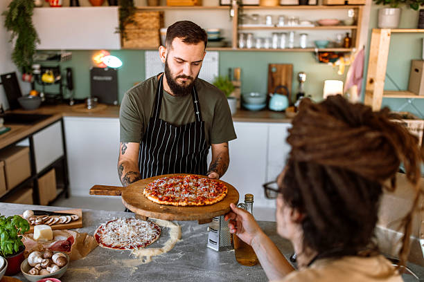 istock Chef serving fresh baked pizza on wooden board 2233176828
