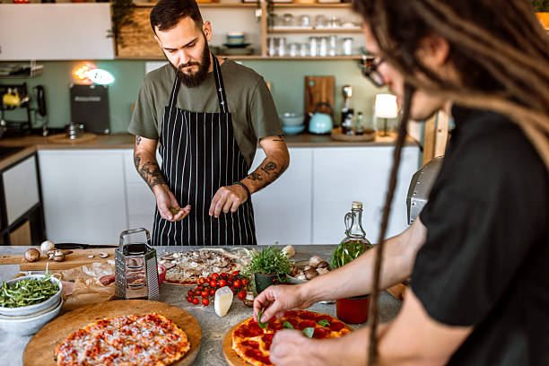istock Putting fresh herbs and spices on pizza. 2233177039