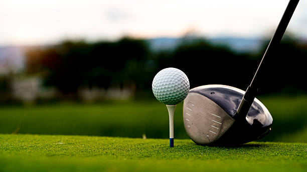 istock Golf ball on green grass in the evening golf course with sunshine background. 2233178125