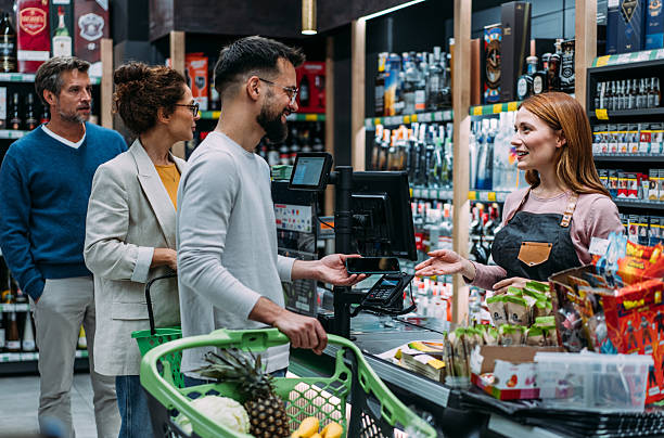 istock Man using phone to make the payment at the supermarket 2233180104