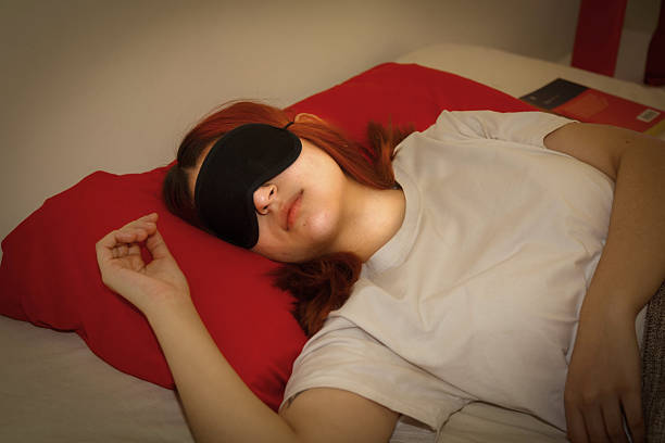 istock girl sleeping with a mask 2233181613