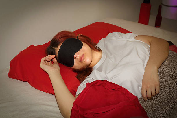istock girl sleeping with a mask 2233181617