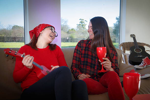 istock womens playing the acoustic guitar and drinking 2233181695
