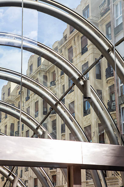 Modern underground station entrance contrasting with traditional Spanish city architetcure