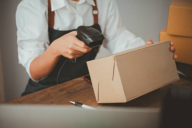 istock Delivery staff scanning cardboard box with barcode scanner to check products for customers 2233185986