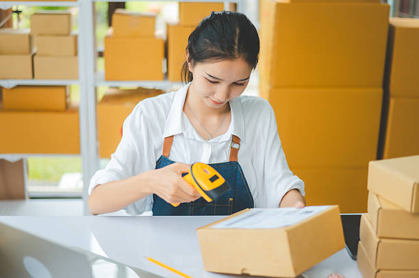 istock online small business owner scans a barcode-labeled parcel with a barcode scanner to verify a customer's order before it is delivered to the customer. 2233186282