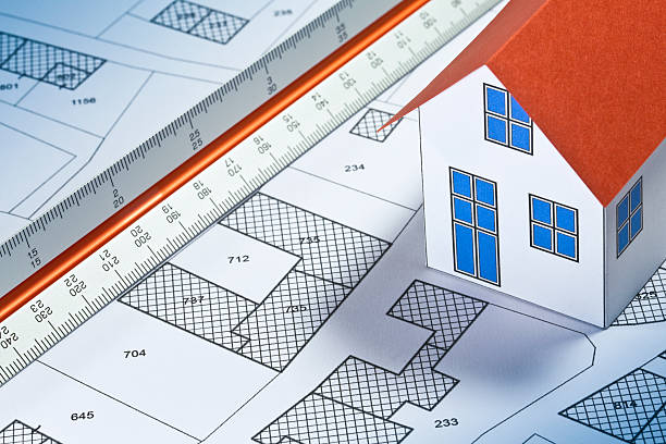 istock REAL ESTATE CONCEPT WITH HOME MODEL, imaginary cadastral map, General Urban Planning and ruler 2233186372