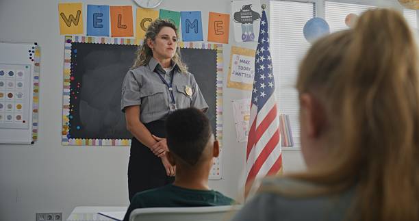 istock American Female TSA Security Officer Explaining Safety Rules to Young Students at Elementary School 2233186891