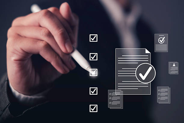 istock Businessman checking digital checklist and document approval. Concept of quality assurance, ISO certification, standard compliance, and business guarantee with futuristic interface. 2233187864