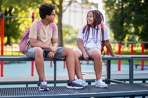 istock Teens sitting at the playground after school and talking 2233189193