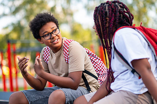 istock Two teens at the playground looking contented and relaxed 2233189202