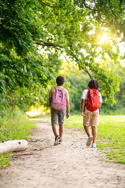 istock Two teens having a walk in the park after school 2233189271