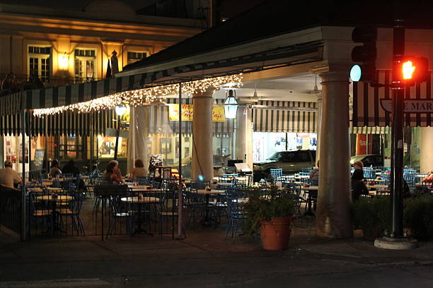 New Orleans, Louisiana, USA. Taken May 29, 2012. Outdoors street side cafe at downtown New Orleans lights outside a store in the evening. Street scene around French Quarter  in New Orleans.