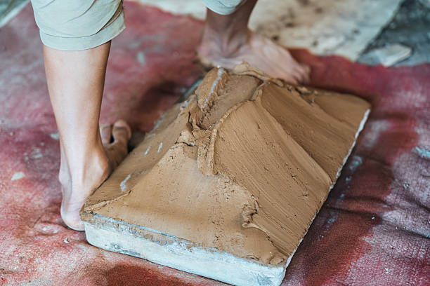 istock Manual clay tile making with worker shaping, drying and organizing terracotta in traditional workshop showing heritage craft and raw material process 2233189922