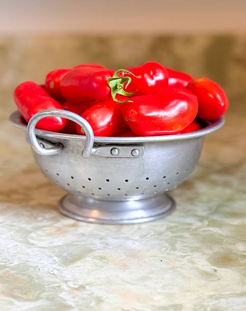 istock Homegrown Roma Tomatoes In A Vintage Colander 2233195196