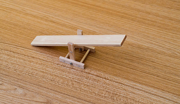 istock Wooden seesaw model on the table 2233196514