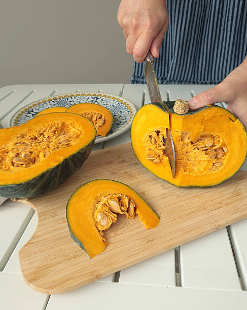 istock Anonymous cut pumpkin on wooden board. 2233197363