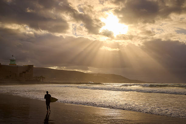 Surfers during beautiful sunset, Las Palmas, Gran Canaria, Spain