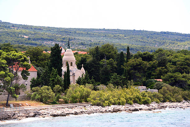 Beach and picturesque cemetery in Supetar, on island Brac, Croatia.