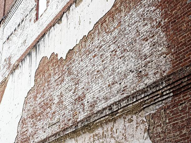 istock Plaster over brick, aged buildings wall showing wear 2233203377
