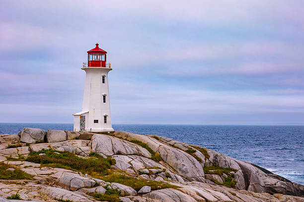 istock Peggy's Cove lighthouse at sunrise with pastel colored sky, Nova Scotia. 2233203547