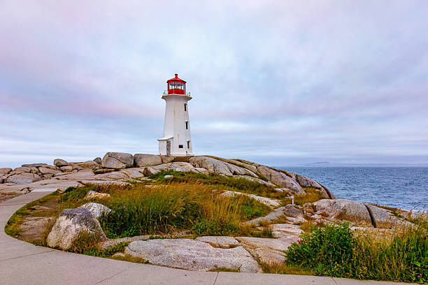 istock Peggy's Cove lighthouse at sunrise with pastel colored sky, Nova Scotia. 2233203549