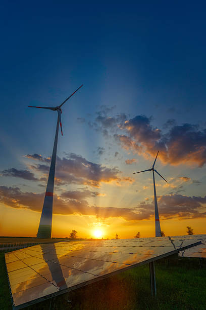 Environmental technology highlighted by a beautiful sunset framing wind turbines and solar panels, illustrating clean and renewable energy solutions for a greener and sustainable future.